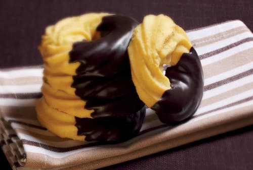 Ciambelline tuffate - Le Ciambelline Tuffate sono squisiti biscotti di friabile pasta frolla tuffati in finissimo cioccolato fondente, per rendere più dolce ogni momento della giornata.

Peso Netto 1000gr
Scadenza 180gg
Dim. Pallet 80x120cm – 9 cart. per strato
Pallettizzazione max 180 cartoni