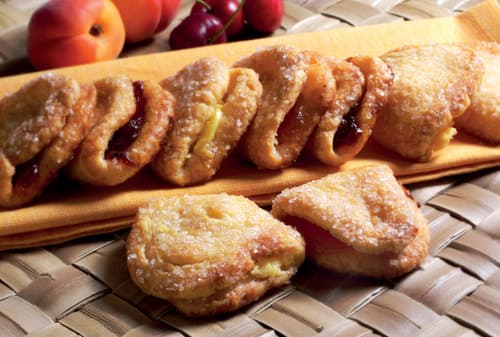 Le sfogline con crema, marmellata di albicocche o ciliegie - Sfogline di leggerissima e croccante pasta sfoglia, ricoperte con granella di zucchero e farcite con delicata crema pasticcera oppure con gustosa marmellata di ciliegie o albicocca.

Peso Netto, per tipo 1000gr
Scadenza 180gg
Dim. Pallet 80x120cm – 9 cart. per strato
Pallettizzazione max 180 cartoni